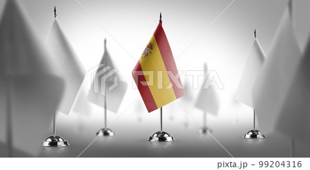 The national flag of the Spain surrounded by white flags 99204316