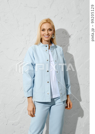 Joyful woman in blue jeans, jacket and white shirt 99205129