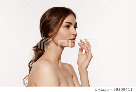 Portrait of young beautiful woman with perfect smooth skin over white background. Taking care after skin with natural cosmetics Portrait of young beautiful woman with perfect smooth skin over white background. Taking care after skin with natural cosmetics 99209411