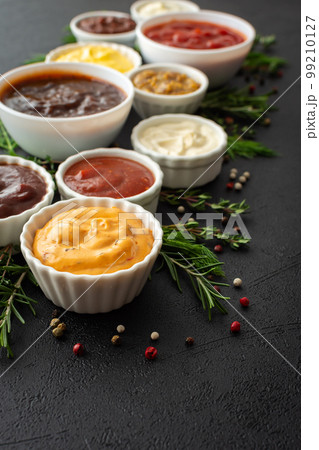 Sauces in bowls with seasonings 99210127