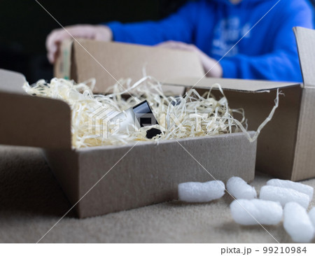 Eco package of parcels and biodegradable filler. Box is filled with a filler that does not harm the environment. Delivery of goods, parcels, delivery service, nature protection. Recycling Eco package of parcels and biodegradable filler. Box is filled with a filler that does not harm the environment. Delivery of goods, parcels, delivery service, nature protection. Recycling 99210984