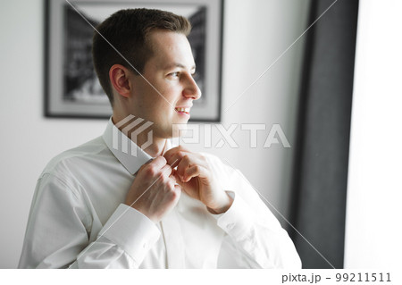 Beautiful man, groom posing and preparing for wedding 99211511