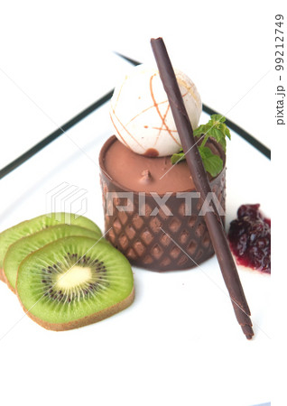 chocolate mousse presented with a scoop of ice cream and natural kiwi chocolate mousse presented with a scoop of ice cream and natural kiwi 99212749