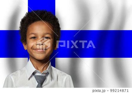 Finnish kid boy on flag of Finland background. Education and childhood concept 99214871