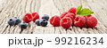 Raspberry and blueberry on old wooden background 99216234
