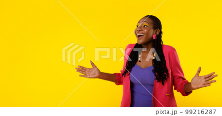 Excited African American Female Shouting Wow Looking Aside, Yellow Background 99216287