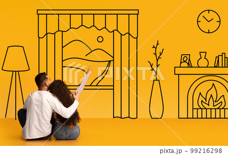 Young couple embracing and pointing at interior doodles Young couple embracing and pointing at interior doodles 99216298