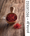 Saffron threads on wooden background 99216502