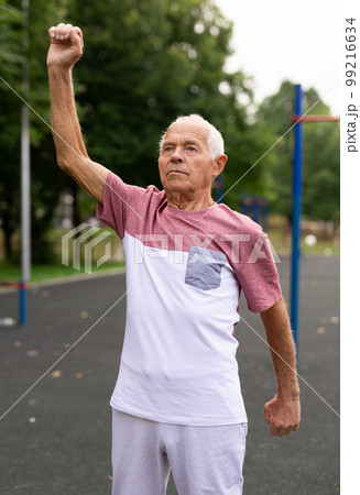 Senior man doing warming up exercises 99216634