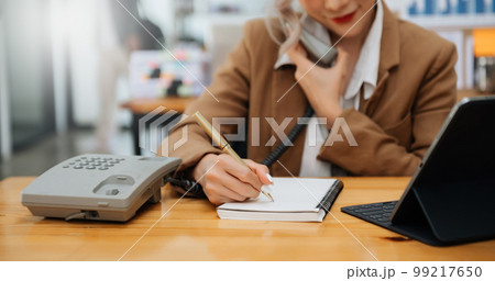 Happy asian business woman have the joy of talking on the smartphone, tablet and laptopon the modern office Happy asian business woman have the joy of talking on the smartphone, tablet and laptopon the modern office 99217650