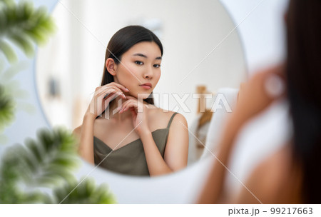 woman looking at mirror 99217663