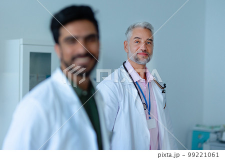 Portrait of mature doctor at hospital room. 99221061
