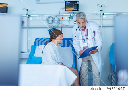 Senior woman sitting in hospital room after chemotherapy. 99221067