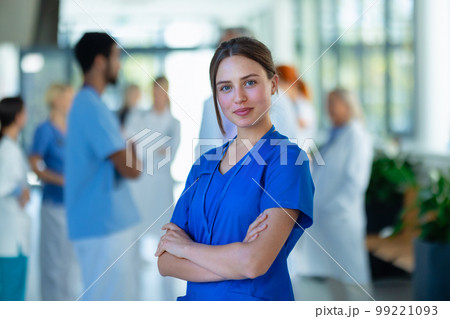 Portrait of young woman doctor at hospital corridor. 99221093