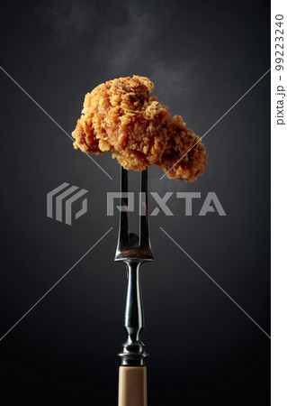 Fried chicken on a fork. 99223240
