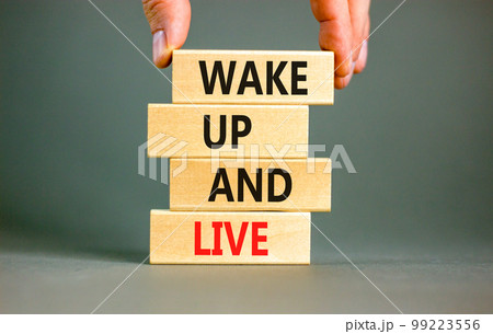 Wake up and live symbol. Concept words Wake up and live on wooden blocks. Beautiful grey table grey background. Businessman hand. Business lifestyle wake up and live concept. Copy space. Wake up and live symbol. Concept words Wake up and live on wooden blocks. Beautiful grey table grey background. Businessman hand. Business lifestyle wake up and live concept. Copy space. 99223556