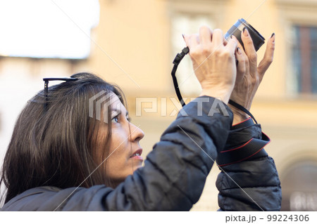 Portrait of photographer woman unfocused background at Florence, Italy. 50mm lens Portrait of photographer woman unfocused background at Florence, Italy. 50mm lens 99224306