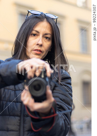 Portrait of photographer woman unfocused background at Florence, Italy. 50mm lens Portrait of photographer woman unfocused background at Florence, Italy. 50mm lens 99224307