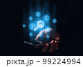 A person holding a smartphone leads the search and verification of electronic documents. Hologram graphics. 99224994