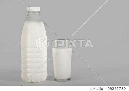 Bottle of milk and a glass on a gray background with a clipping path. Dairy products Bottle of milk and a glass on a gray background with a clipping path. Dairy products 99225780