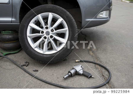 The car is at a car service. Replacing wheels on a car. Close-up 99225984