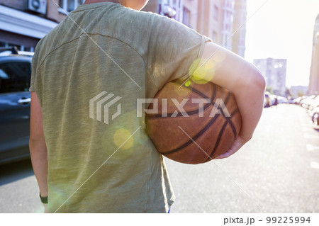 Back view of a man holding a basketball. Close-up Back view of a man holding a basketball. Close-up 99225994