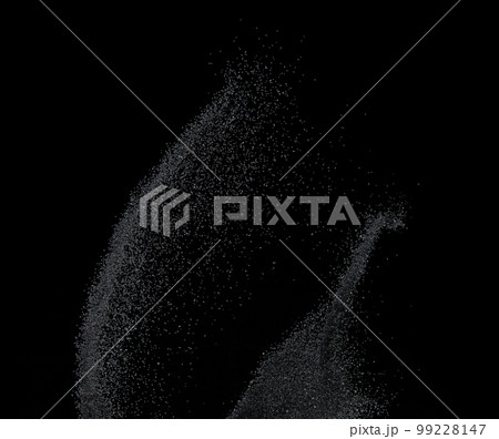 Million of black sand explosion, Photo image of falling down sands flying. Freeze shot on black background isolated overlay. Tiny Fine sand dust magnet as particle disintegrate science 99228147