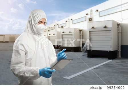 Asian worker or engineer wear protective coverall suit work at warehouse Asian worker or engineer wear protective coverall suit work at warehouse 99234002