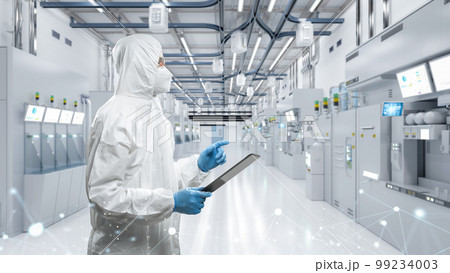 Worker or engineer wears protective suit or coverall suit work in semiconductor manufacturing factory Worker or engineer wears protective suit or coverall suit work in semiconductor manufacturing factory 99234003