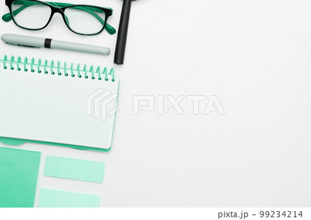 Office Supplies Over Desk With Keyboard And Glasses And Coffee Cup For Working Remotely, Assorted School Utilities For Studying With Hot Drink And Eyeglasses. Office Supplies Over Desk With Keyboard And Glasses And Coffee Cup For Working Remotely, Assorted School Utilities For Studying With Hot Drink And Eyeglasses. 99234214