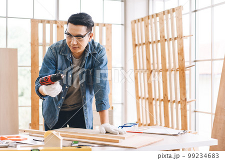 Middle age adult man carpenter job at home workshop 99234683
