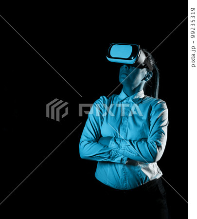 Woman Wearing Vr Glasses And Looking On Important Messages. Businesswoman Having Virtual Reality Eyeglasses And Showing Crutial Informations. Woman Wearing Vr Glasses And Looking On Important Messages. Businesswoman Having Virtual Reality Eyeglasses And Showing Crutial Informations. 99235319