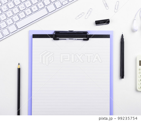 Colored paper with important message lying desk near keyboard. Main information written on notebook. School supplies. Multiple Assorted Collection Office Stationery. 99235754