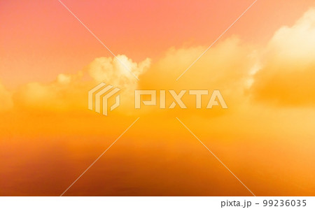 Aerial view red burning sunset over the sea with rocky volcanic cliff. Abstract nature summer sunset ocean sea background. Small waves on golden warm water surface Evening. Horizon. Nobody. No people. 99236035