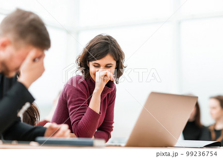 young people discussing something sitting at the table young people discussing something sitting at the table 99236754