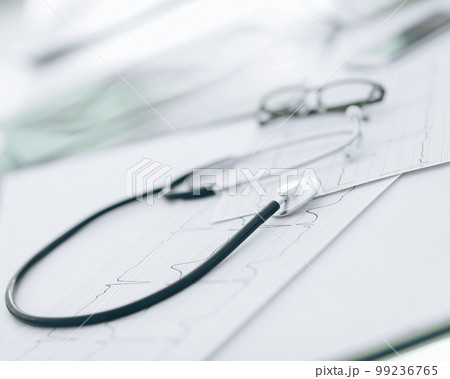 close up. glasses and a stethoscope on the therapist's Desk close up. glasses and a stethoscope on the therapist's Desk 99236765