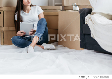 young woman making online purchases for her new apartment young woman making online purchases for her new apartment 99236806