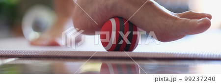 Female heel massage with massage tool for myofascial therapy closeup 99237240