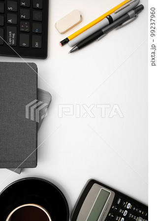 Coffee Cup Standing on Desk. Important infrormation written on paper. Different Office Supplies, Pencils, Pens, Marckers. Computer keyboard. Text on wood table. 99237960