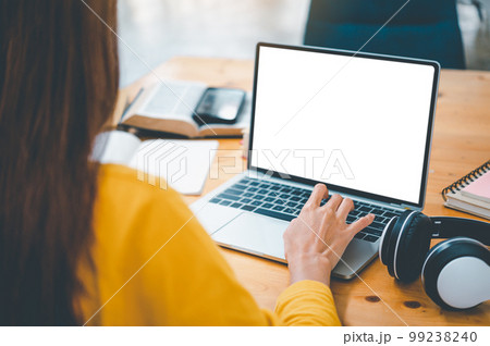 young student wearing headphones studies online, distance learning, and keeps up to date on the global coronavirus pandemic. young student wearing headphones studies online, distance learning, and keeps up to date on the global coronavirus pandemic. 99238240