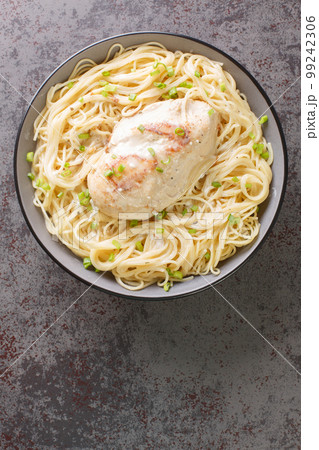 Angel chicken pasta made with condensed soup and cream cheese closeup in the bowl. Vertical top view Angel chicken pasta made with condensed soup and cream cheese closeup in the bowl. Vertical top view 99242306