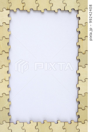 Frame of wooden puzzles with a white background. A puzzle for your ideas. Top view, mock up Frame of wooden puzzles with a white background. A puzzle for your ideas. Top view, mock up 99242408