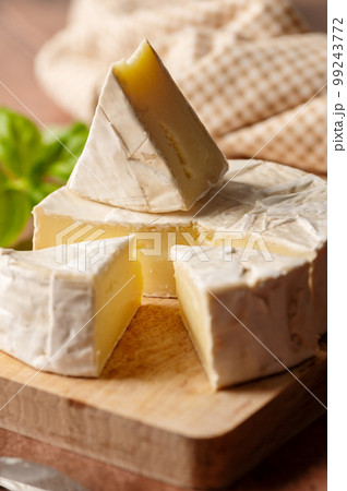 Close up Brie, soft cheese slices on cutting board. Copy space Close up Brie, soft cheese slices on cutting board. Copy space 99243772
