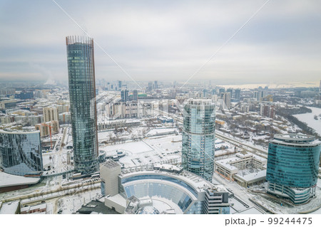 Yekaterinburg city with Buildings of Regional Government and Parliament, Dramatic Theatre, Iset Tower, Yeltsin Center, panoramic view at winter sunset. 99244475