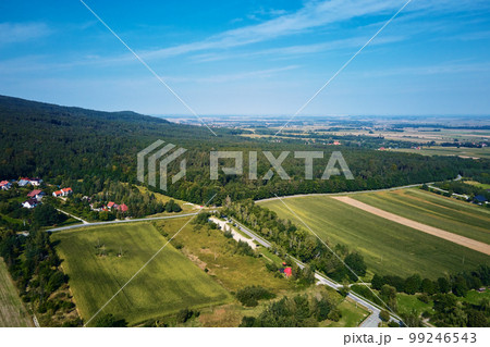 Mountain village, aerial view. Beautiful mountain landscape with residential neighborhood and green fields. Countryside view 99246543