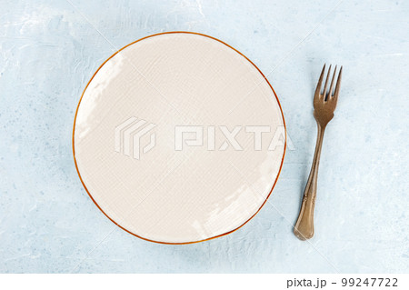 An empty plate with a fork, overhead flat lay shot, the concept of food An empty plate with a fork, overhead flat lay shot, the concept of food 99247722