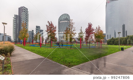 Panorama showing skyscrapers and biblioteca from park with green lawn timelapse in Milan Panorama showing skyscrapers and biblioteca from park with green lawn timelapse in Milan 99247806