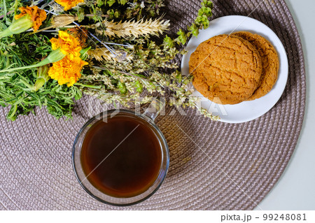 A cup of aromatic coffee and oatmeal cookies on the table. View from above. Instant coffee. A cup of aromatic coffee and oatmeal cookies on the table. View from above. Instant coffee. 99248081