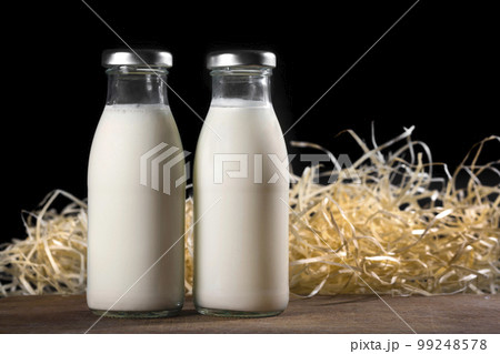 Two bottles of fresh milk on a black background. Healthy food 99248578