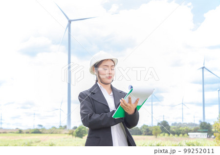 asian female and man Manager Engineer in Safety Helmet Checking With Tablet An Operation Of Solar Panel System At Solar Station in farm. 99252011